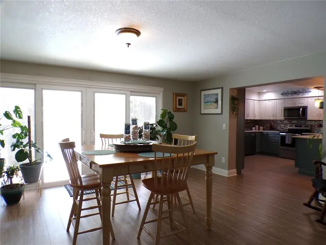 a dining room with furniture and wooden floor