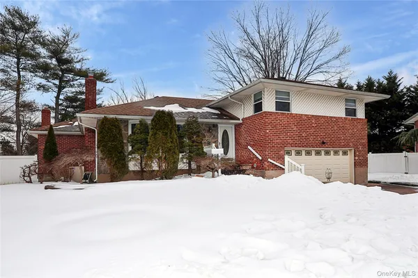 a view of a house with snow on the road