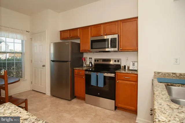 a kitchen with stainless steel appliances a refrigerator stove and microwave