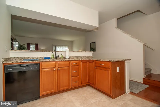 a bathroom with a granite countertop double vanity sink and mirror