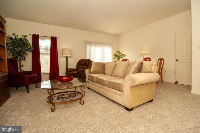 a living room with furniture gym equipment and a large window