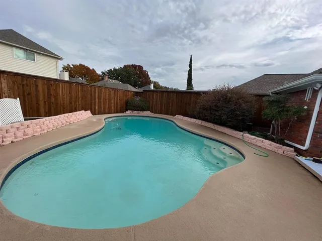 a view of a backyard with a small pool