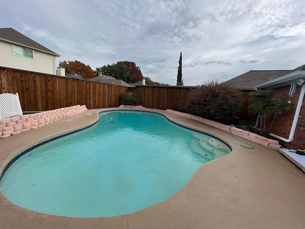 1030 Clinton Street Carrollton, TX 75007 - Photo 1 of 33 a view of a backyard with a small pool