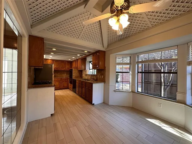 a view of large kitchen with wooden floor and a kitchen space