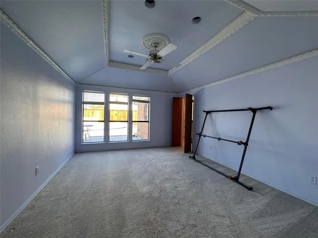 a view of a livingroom with a ceiling fan and window