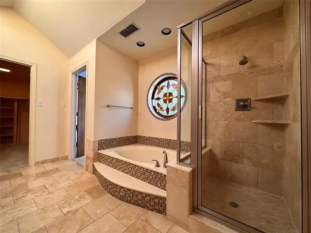 a bathroom with a bathtub and a shower