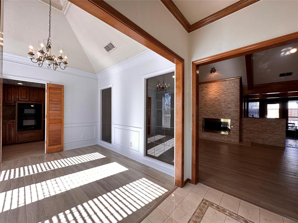 1030 Clinton Street Carrollton, TX 75007 - Photo 6 of 33 a view of a hallway with a chandelier