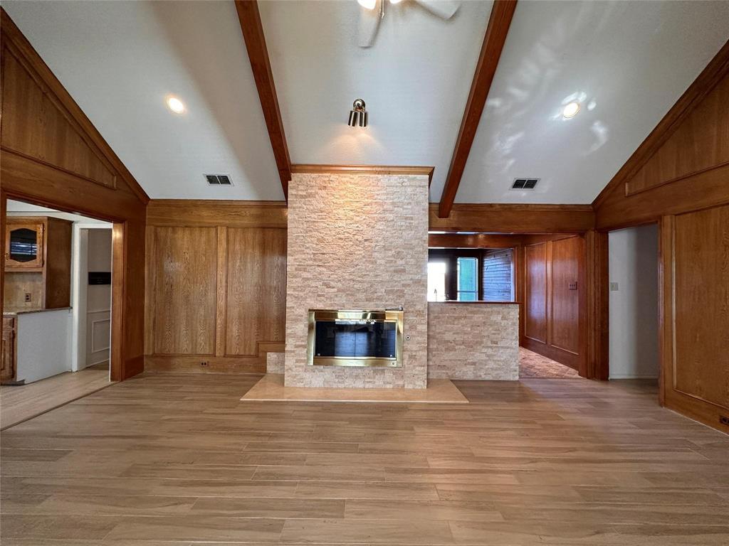 1030 Clinton Street Carrollton, TX 75007 - Photo 8 of 33 an empty room with wooden floor and windows