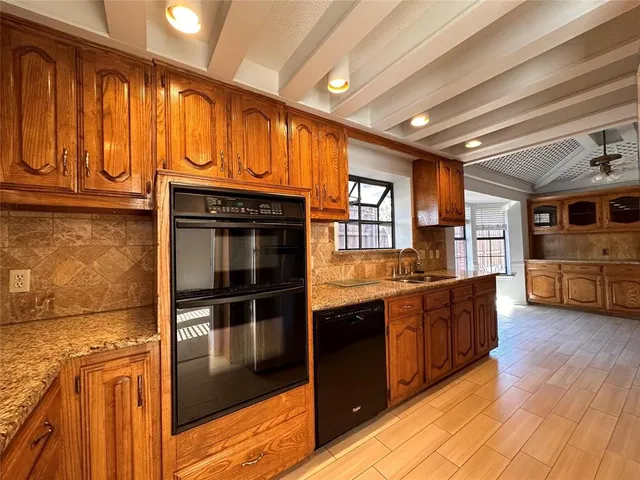 a kitchen with stainless steel appliances granite countertop a stove a sink and a refrigerator