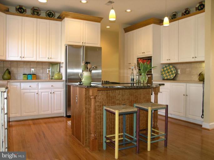 1300 Stamford Way Reston, VA 20194 - Photo 12 of 30 a kitchen with stainless steel appliances granite countertop a refrigerator sink and cabinets