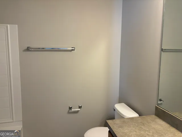 a white toilet sitting next to a bathroom sink