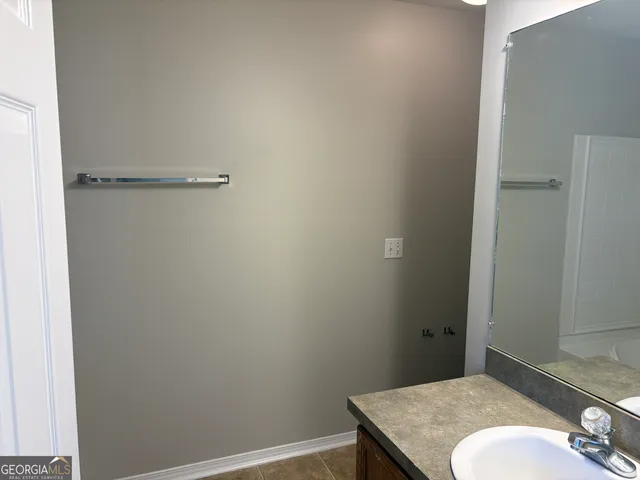 a bathroom with a granite countertop sink