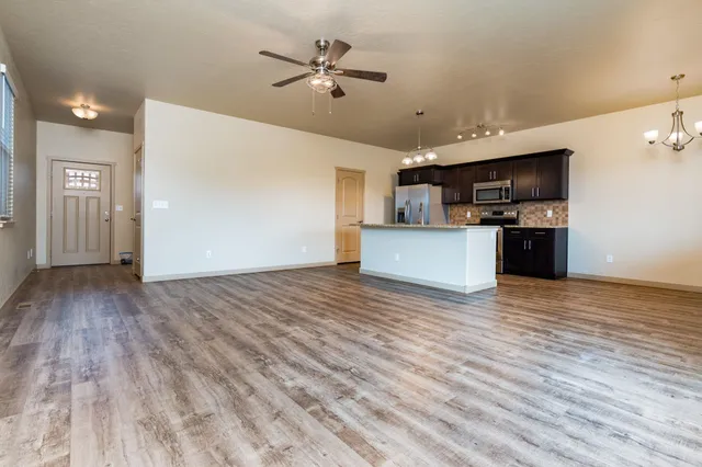 a view of a kitchen with a sink and a refrigerator
