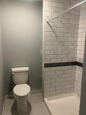 a bathroom with a shower and bathtub