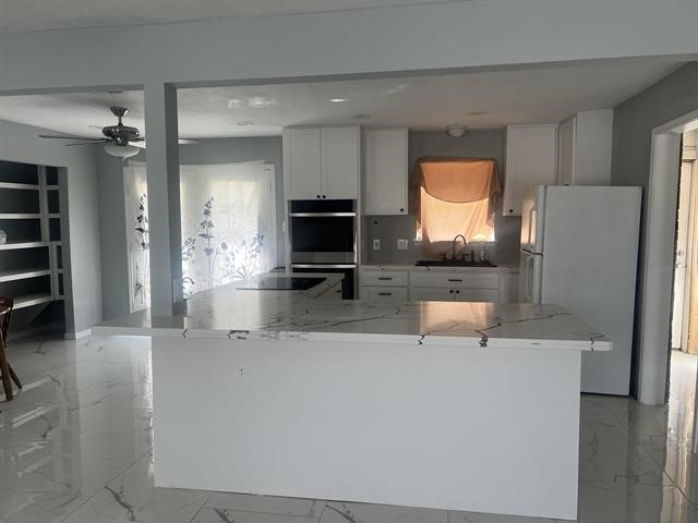 775 West Herring Street Sour Lake, TX 77659 - Photo 18 of 21 a kitchen with stainless steel appliances a refrigerator and a stove top oven