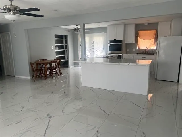 a view of a livingroom with furniture window and wooden floor