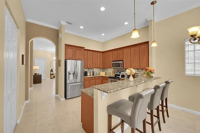 a kitchen with refrigerator and windows
