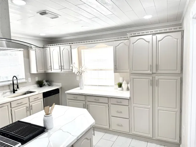 a kitchen with a sink cabinets and window