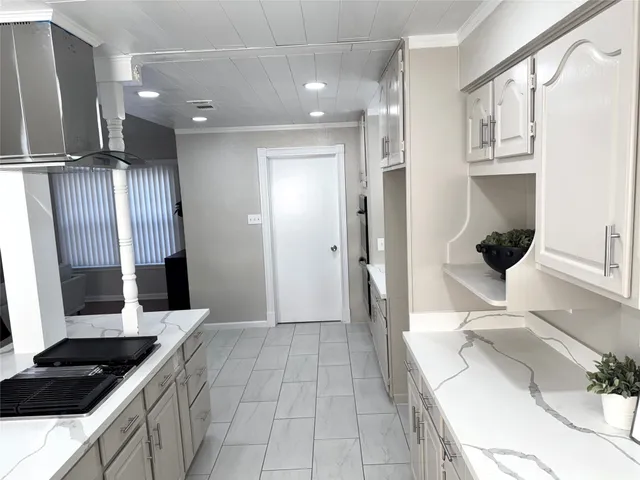 a kitchen with stainless steel appliances kitchen island granite countertop a refrigerator and a sink