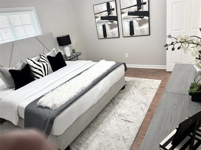 a bedroom with bed and a night stand