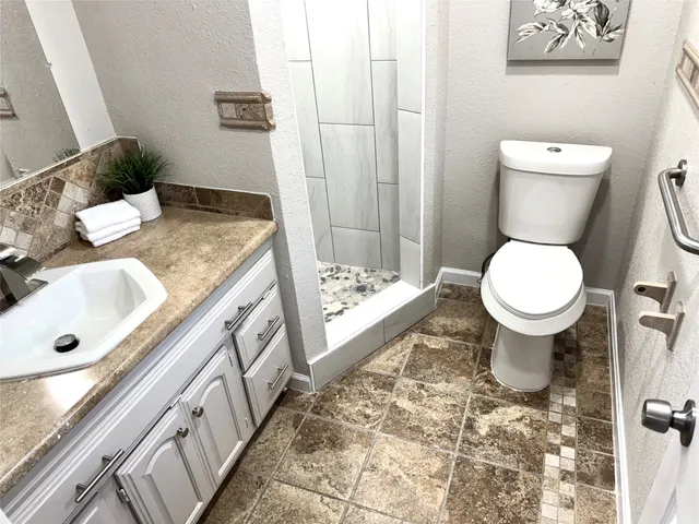 a bathroom with a sink toilet and shower