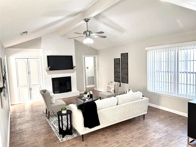 a living room with furniture fireplace and flat screen tv