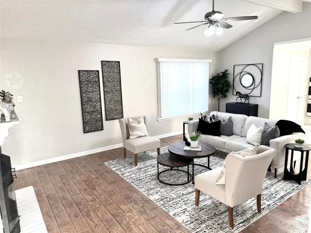 a living room with furniture a rug and a window