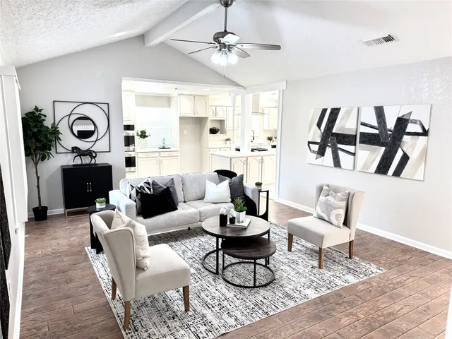 a living room with furniture and a clock