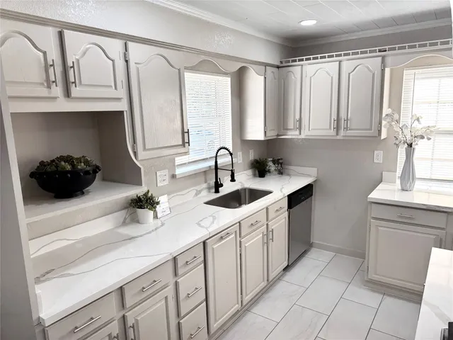 a kitchen with a sink and cabinets