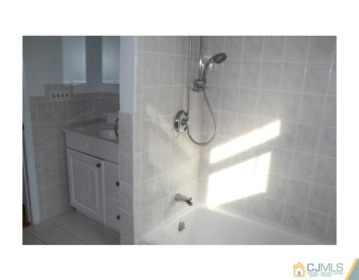 8 Fishel Road Edison, NJ 08820 - Photo 3 of 6 a bathroom with a sink and shower