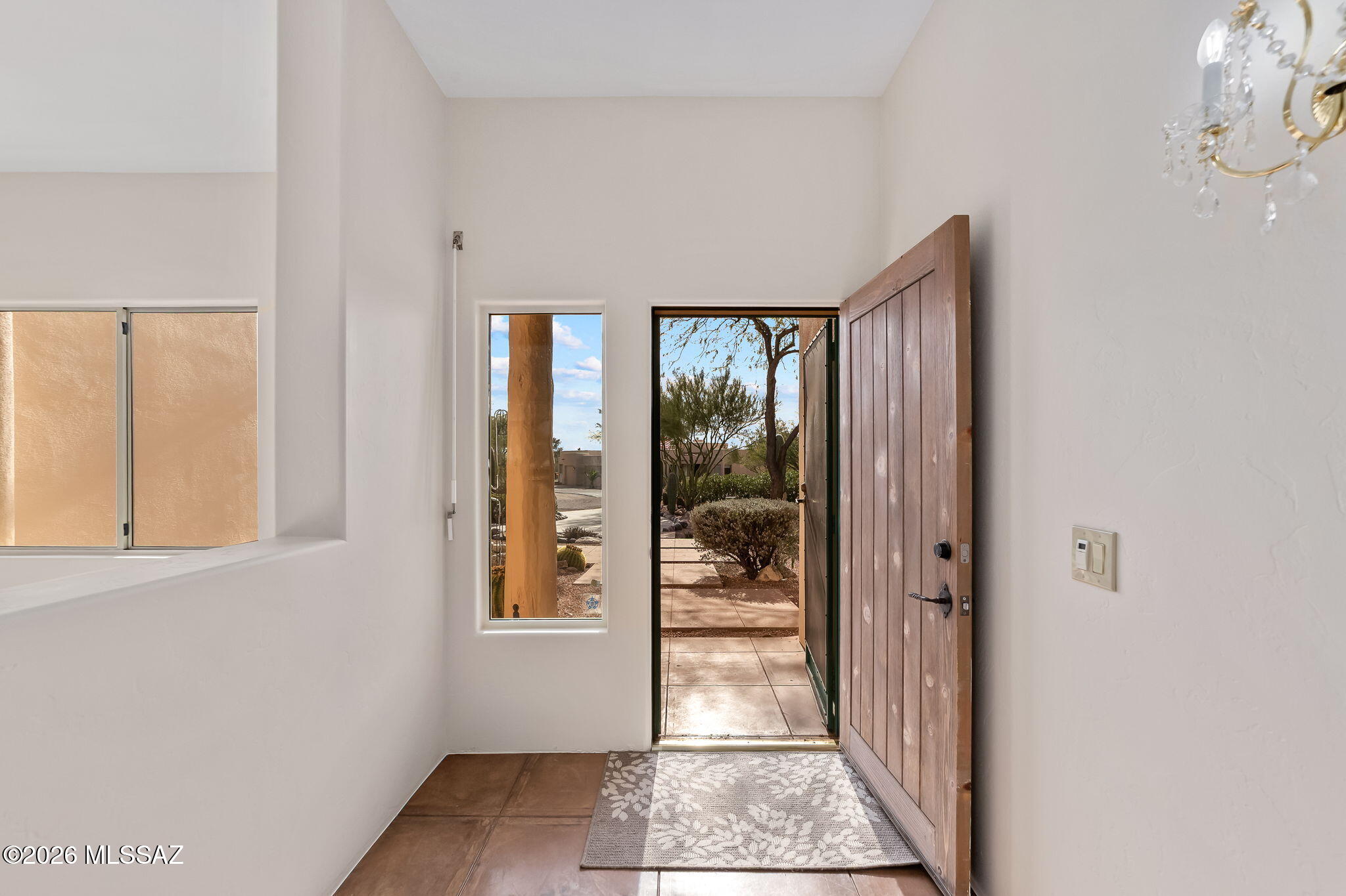 3655 North Harrison Road Tucson, AZ 85749 - Photo 9 of 51 a view of a hallway with a glass door and a window