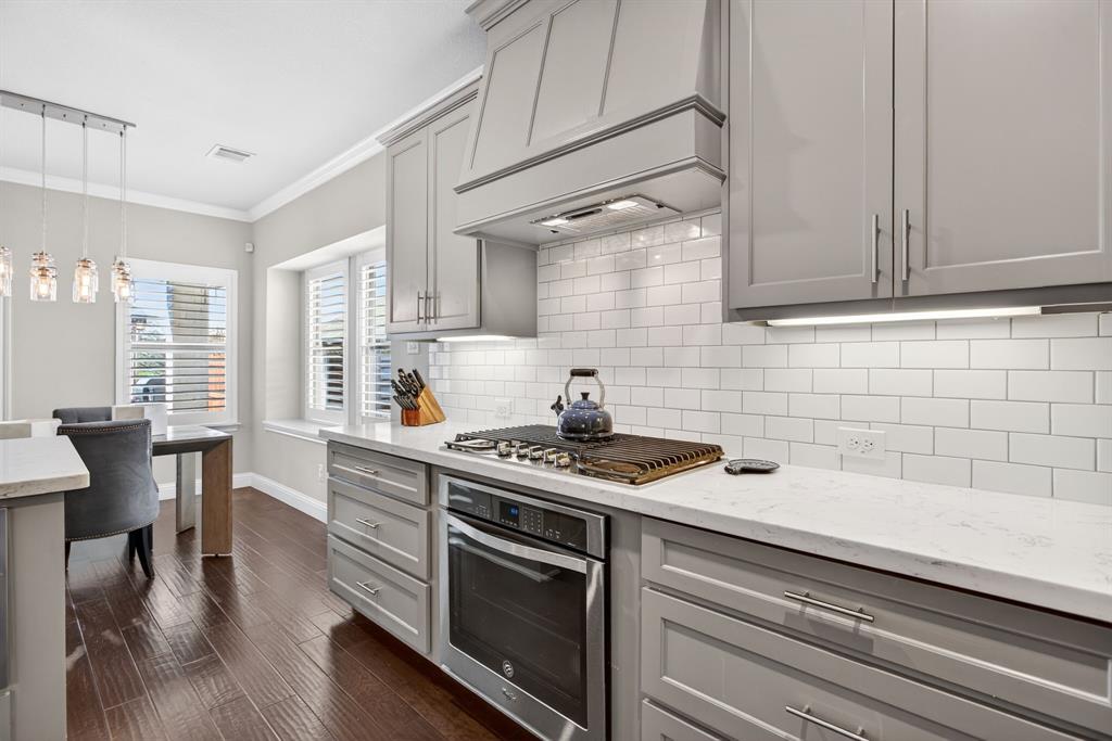 5213 Scott Road Fort Worth, TX 76114 - Photo 13 of 35 a kitchen with stainless steel appliances a stove a sink cabinets and wooden floor