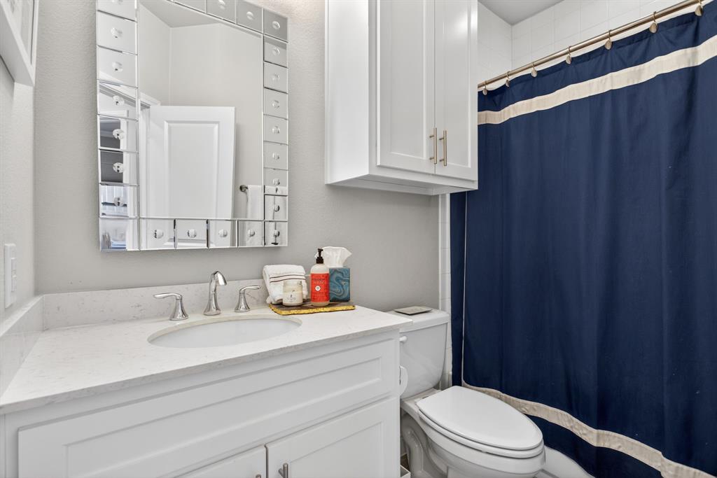 5213 Scott Road Fort Worth, TX 76114 - Photo 26 of 35 a bathroom with a sink a toilet and vanity