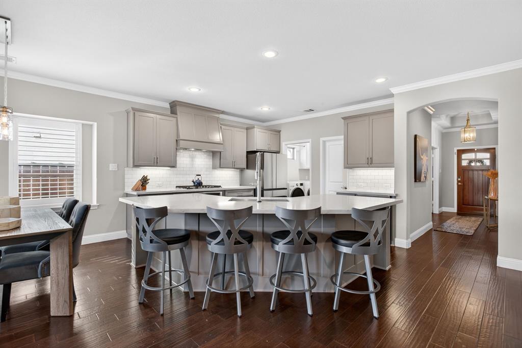 5213 Scott Road Fort Worth, TX 76114 - Photo 7 of 35 a dining room with stainless steel appliances kitchen island granite countertop a table chairs a sink and dishwasher