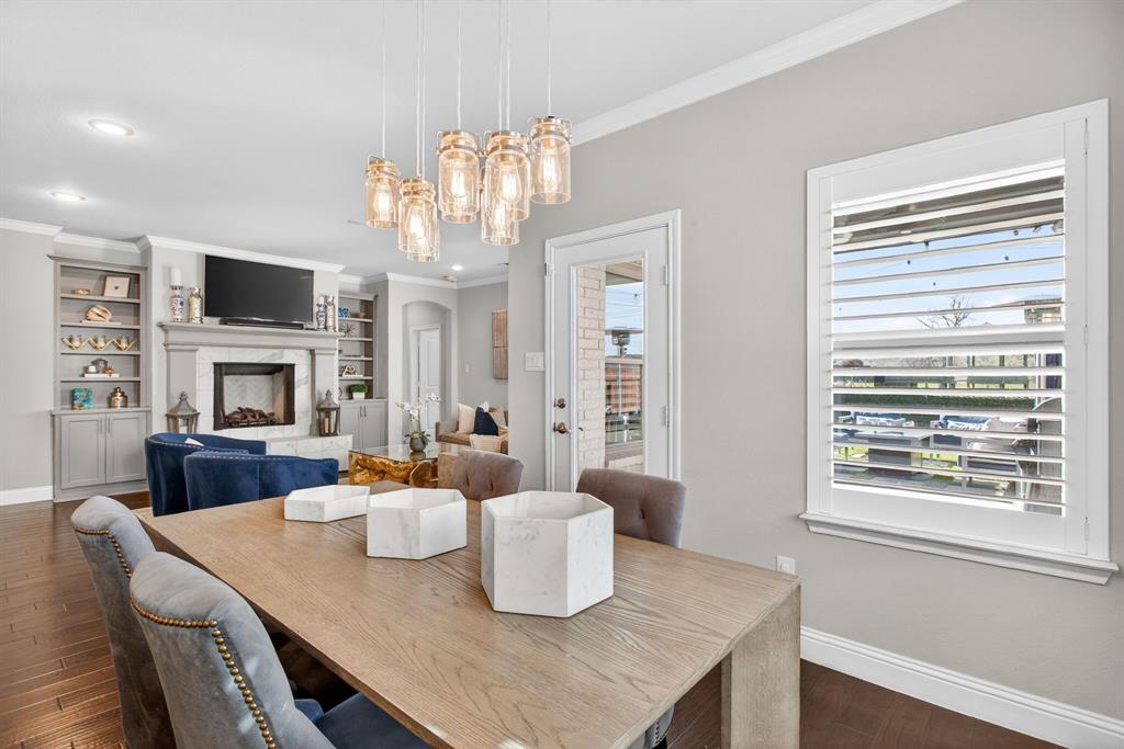 5213 Scott Road Fort Worth, TX 76114 - Photo 8 of 35 a view of a dining room with furniture a fireplace and wooden floor