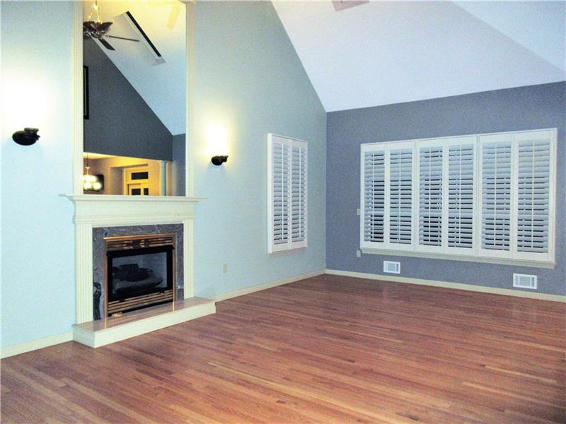 185 Mesa Drive Freeport, PA 16229 - Photo 2 of 25 This freshly painted, large living room boasts hardwood floors, a gas fireplace with marble accent and large mirror above the mantle, custom blinds, a lighted ceiling fan and lots of natural light provided by the two skylights in the cathedral ceiling!