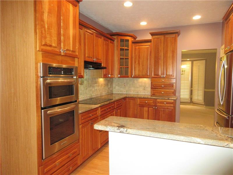 185 Mesa Drive Freeport, PA 16229 - Photo 5 of 25 The kitchen offers everything that the family chef needs including stainless steel appliances, an electric cooktop, built in oven and microwave, cherry cabinets with under cabinet lighting, granite counter tops, self closing drawers, a double bowl stainless steel sink, a peninsula island, a pantry, recessed lighting, hardwood floors, plus it is open to the kitchen dining area and living room, and is conveniently located next to the formal dining room.