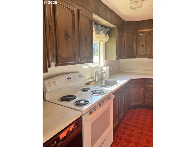 a kitchen that has a sink and a stove