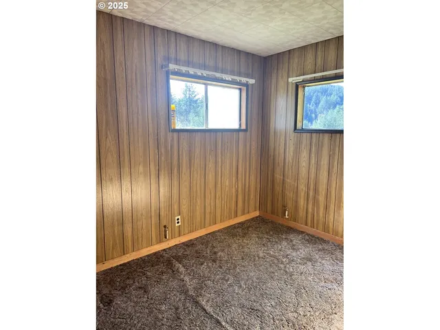 a view of an empty room with windows