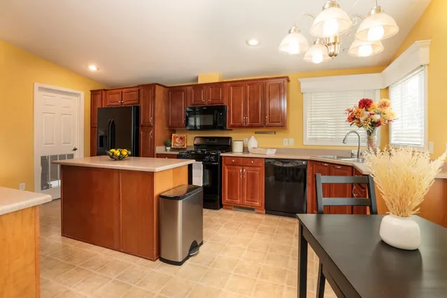 a kitchen with stainless steel appliances granite countertop a stove refrigerator and a microwave