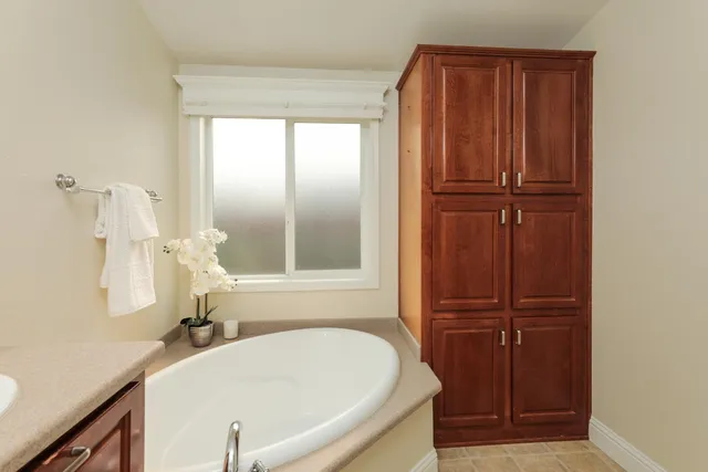 a bathroom with a tub and a sink