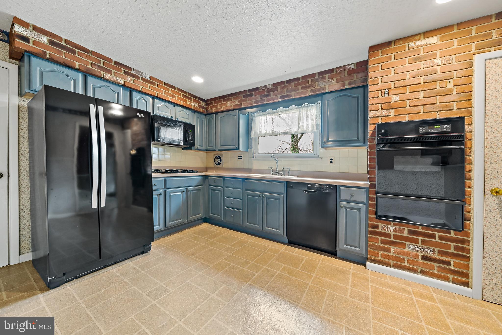 106 Forest Road Cherry Hill, NJ 08034 - Photo 6 of 21 Kitchen Boasts Laminate Floor & Brick Wall Accent