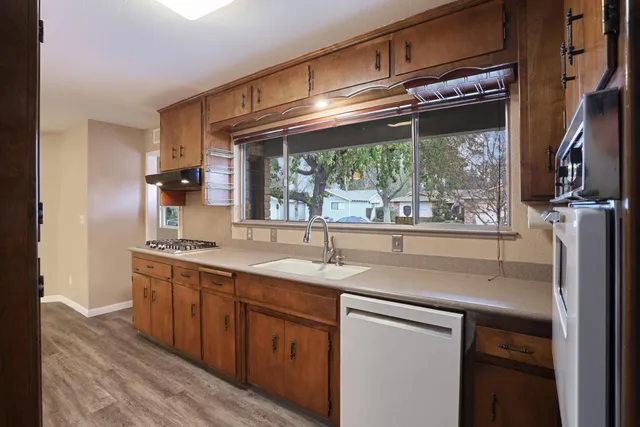a kitchen with a sink and wooden cabinets