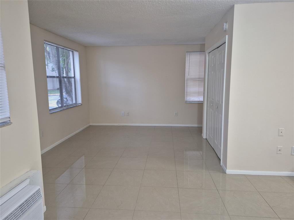 4481 West McNab Road, Unit 10 Pompano Beach, FL 33069 - Photo 11 of 16 an empty room with windows