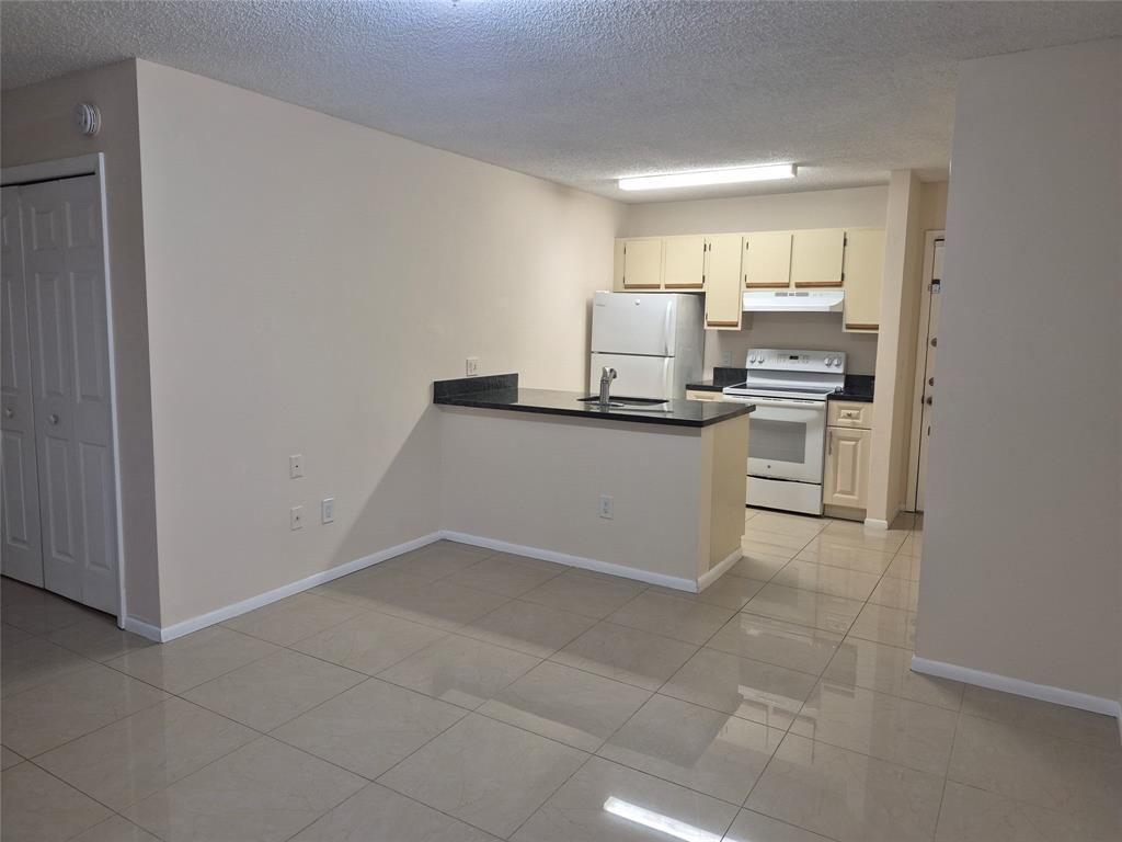 4481 West McNab Road, Unit 10 Pompano Beach, FL 33069 - Photo 6 of 16 a kitchen with stainless steel appliances a sink stove and cabinets