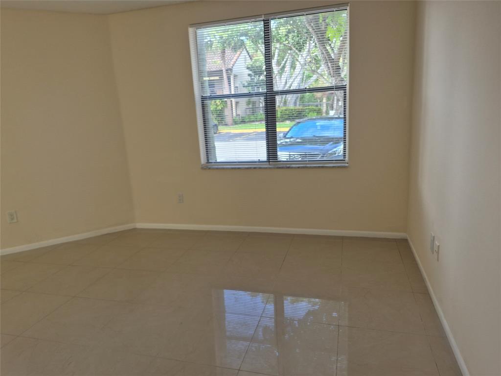 4481 West McNab Road, Unit 10 Pompano Beach, FL 33069 - Photo 10 of 16 an empty room with a window
