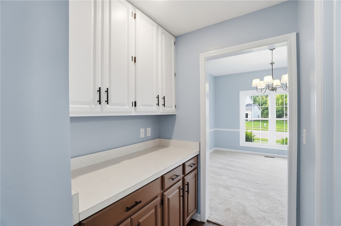 10 Chase Court Springboro, OH 45066 - Photo 25 of 75 This interior hallway features functional cabinetry and views into a brightly lit adjacent room.