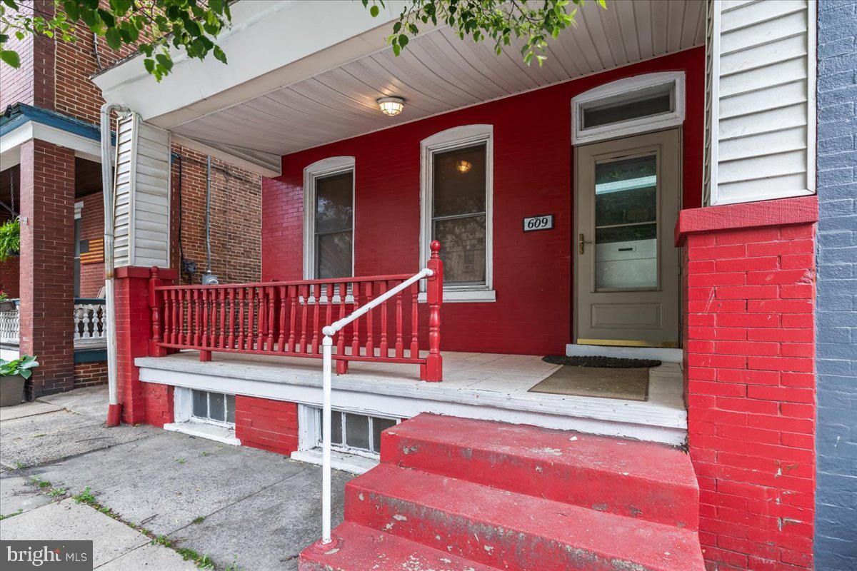 Charming red entryway welcomes you.
