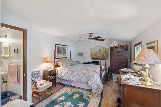 a bedroom with a bed and wooden floor