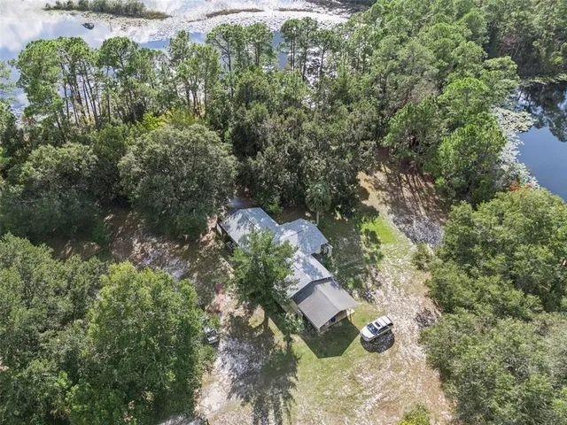 an aerial view of a house with a yard